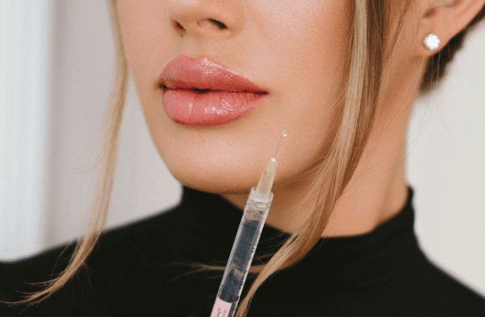 Nurse injector in black with syringe
